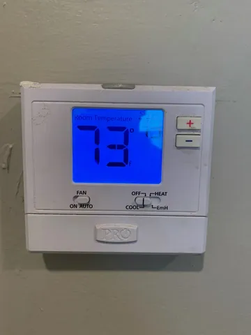 an empty room with closet and a chandelier fan