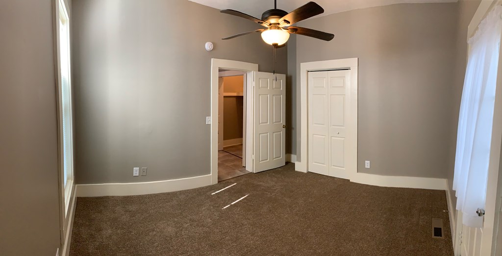 1360 Rhodes Street, Unit B Columbus, GA 31901 - Photo 13 of 14 an empty room with closet and a chandelier fan