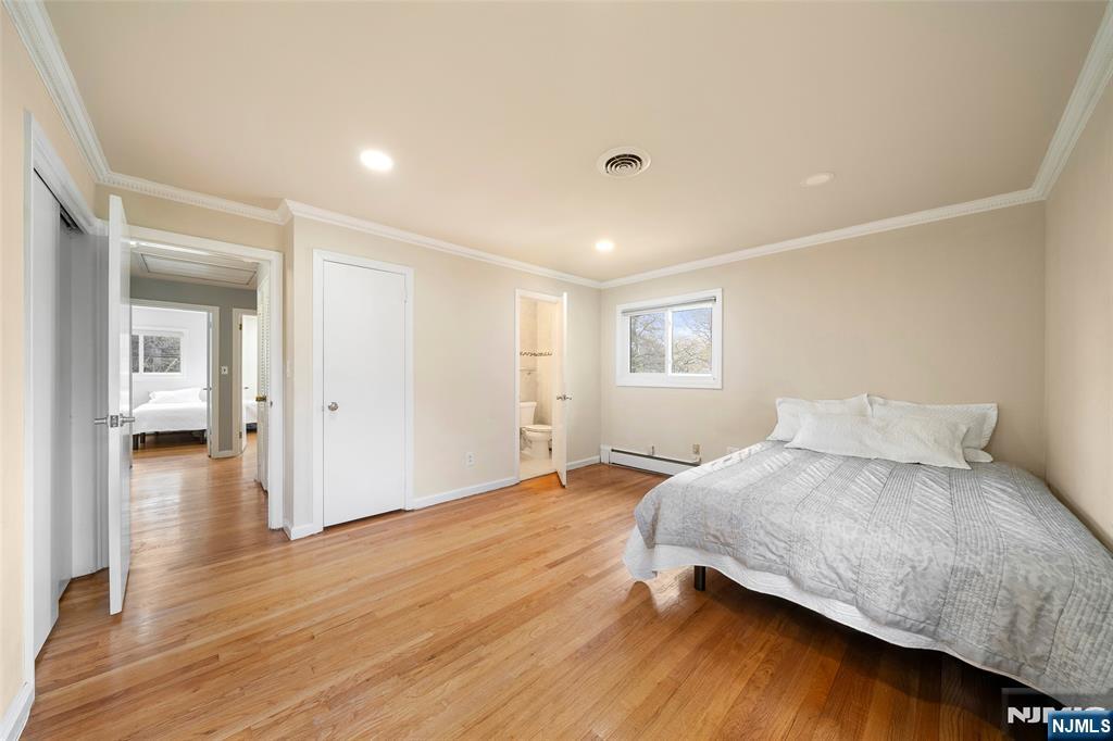 970 Soldier Hill Road Emerson, NJ 07630 - Photo 17 of 37 a bedroom with a bed and wooden floor
