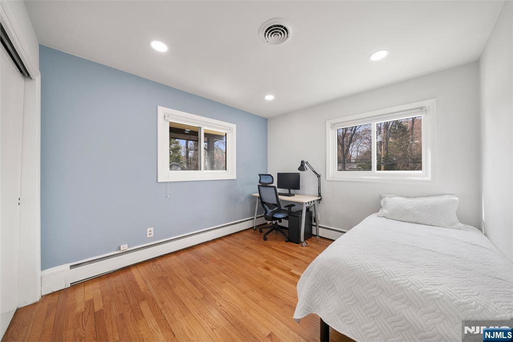 970 Soldier Hill Road Emerson, NJ 07630 - Photo 19 of 37 a bedroom with a bed and a desk