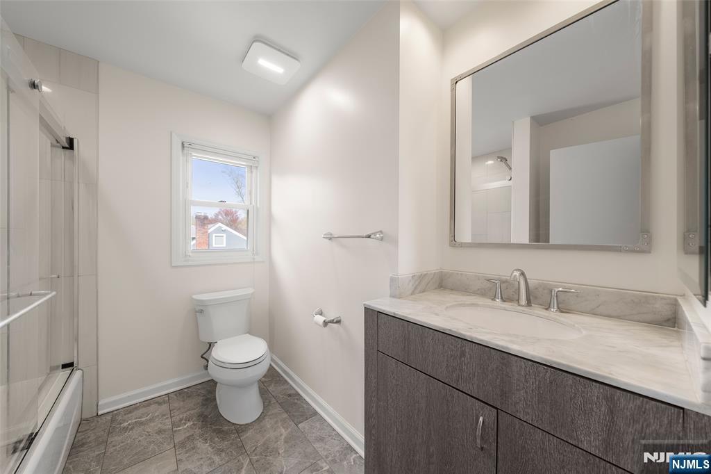 970 Soldier Hill Road Emerson, NJ 07630 - Photo 20 of 37 a bathroom with a toilet sink and mirror
