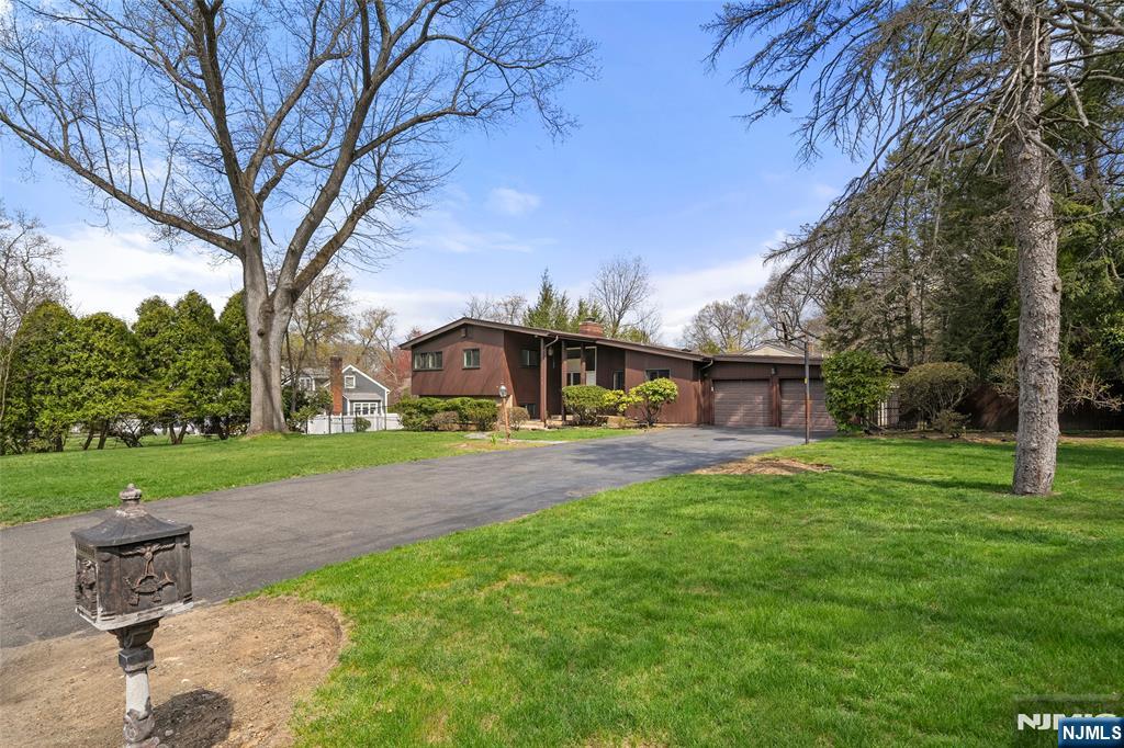 970 Soldier Hill Road Emerson, NJ 07630 - Photo 2 of 37 a view of a patio with a table and chairs under an umbrella