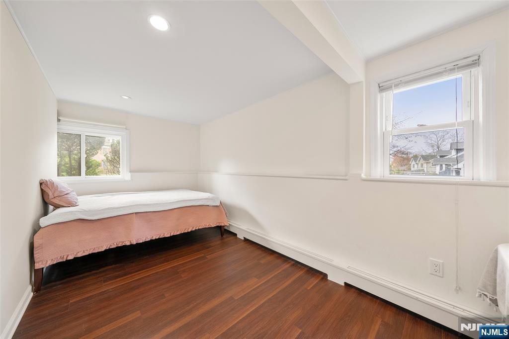 970 Soldier Hill Road Emerson, NJ 07630 - Photo 24 of 37 a bed sitting in a bedroom next to a window