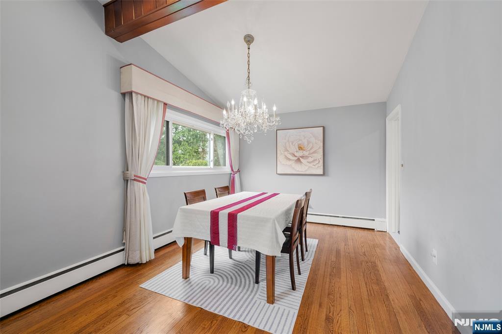 970 Soldier Hill Road Emerson, NJ 07630 - Photo 8 of 37 a view of a dining room with furniture a chandelier and wooden floor