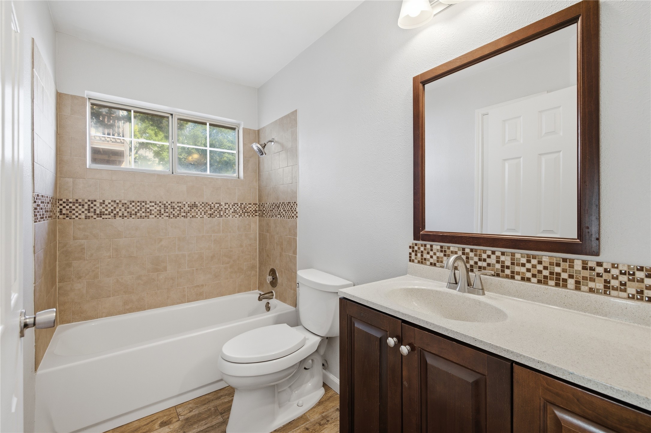 2922 Wickersham Lane Austin, TX 78741 - Photo 10 of 26 a bathroom with a sink a toilet and shower