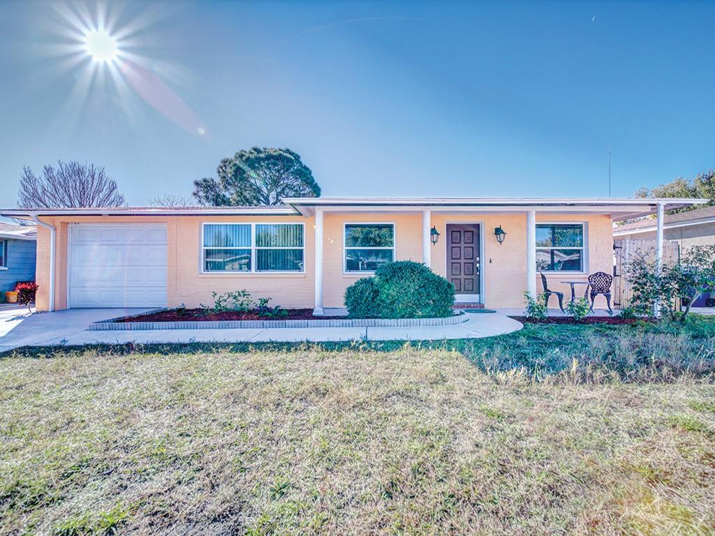 3338 Chauncy Road Holiday, FL 34691 - Photo 1 of 1 a front view of a house with garden