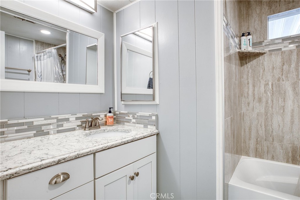 1595 Los Osos Valley Road, Unit 11A Los Osos, CA 93402 - Photo 16 of 31 a bathroom with a granite countertop sink and a mirror