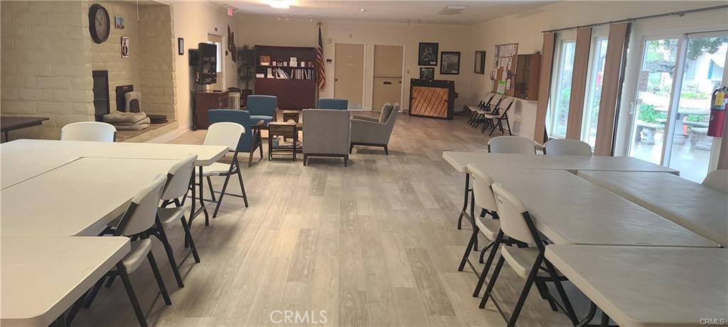 1595 Los Osos Valley Road, Unit 11A Los Osos, CA 93402 - Photo 19 of 31 a view of a dining room with furniture window and wooden floor