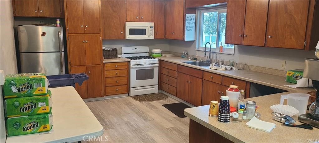 1595 Los Osos Valley Road, Unit 11A Los Osos, CA 93402 - Photo 20 of 31 a kitchen with stainless steel appliances granite countertop a sink dishwasher stove refrigerator and cabinets