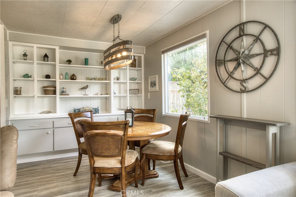 1595 Los Osos Valley Road, Unit 11A Los Osos, CA 93402 - Photo 9 of 31 a dining room with furniture a chandelier and wooden floor