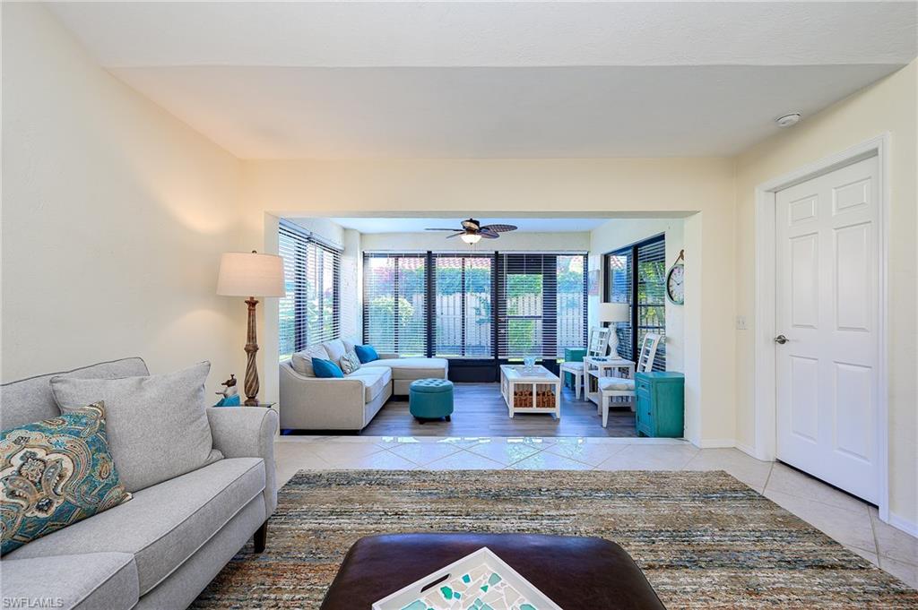833 Reef Point Circle Naples, FL 34108 - Photo 14 of 41 Living room with light tile patterned floors and ceiling fan