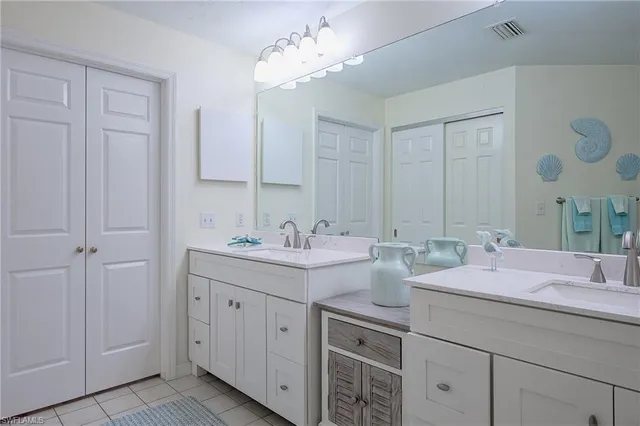 a bathroom with a granite countertop sink a toilet and a mirror