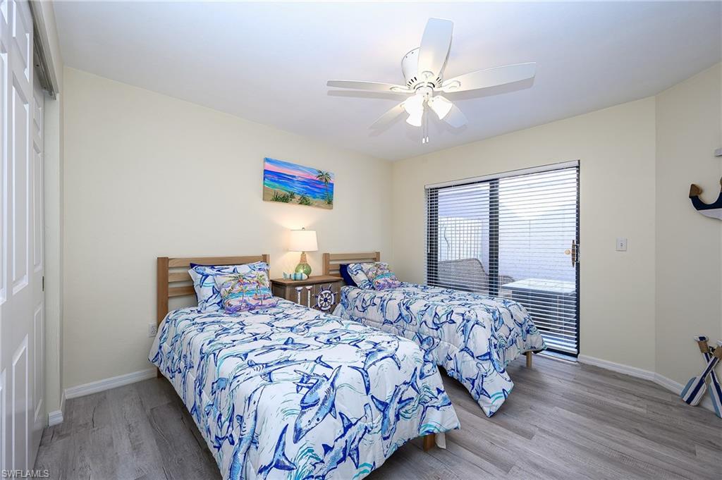 833 Reef Point Circle Naples, FL 34108 - Photo 23 of 41 Bedroom featuring light wood-style flooring, a ceiling fan, and a closet