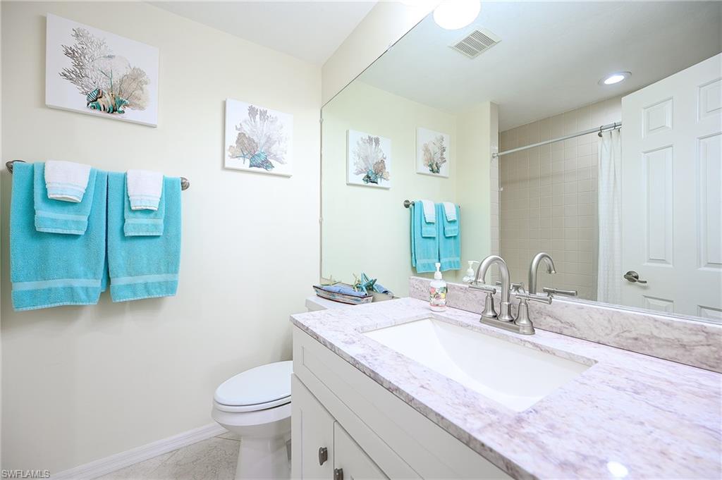 833 Reef Point Circle Naples, FL 34108 - Photo 24 of 41 Full bathroom with vanity, curtained shower, and recessed lighting