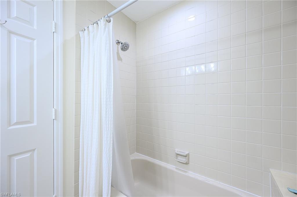 833 Reef Point Circle Naples, FL 34108 - Photo 26 of 41 Bathroom with shower / tub combo with curtain