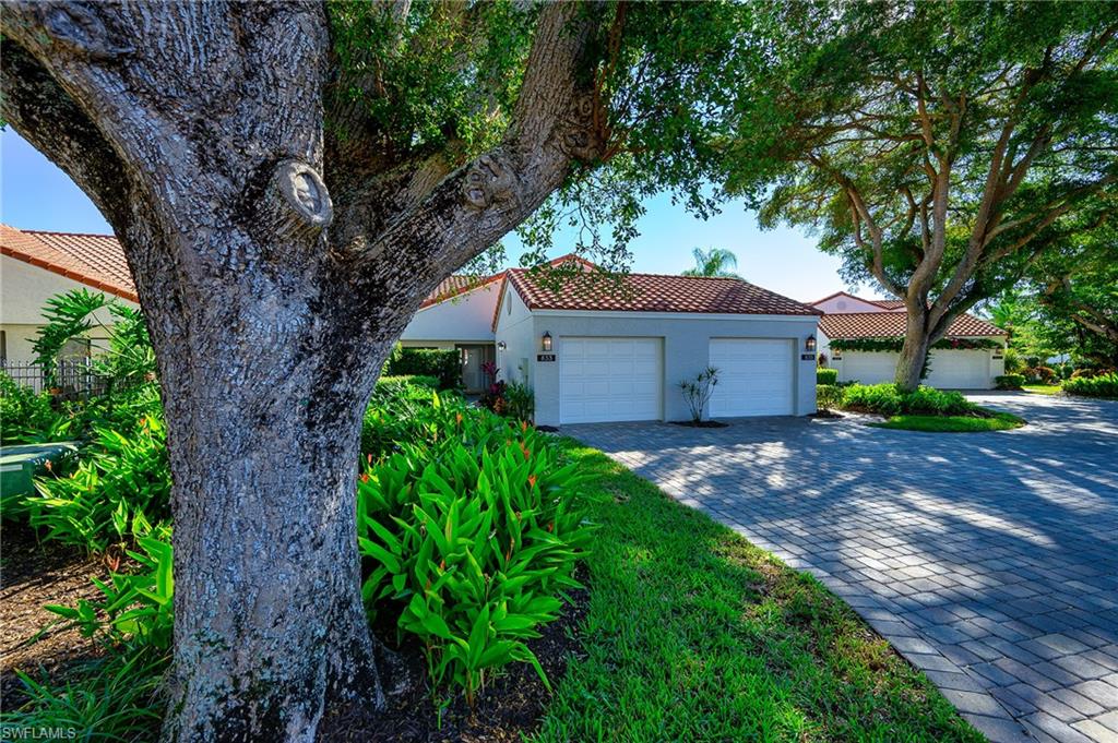 833 Reef Point Circle Naples, FL 34108 - Photo 27 of 41 Mediterranean / spanish home featuring a tile roof, decorative driveway, stucco siding, and an attached garage