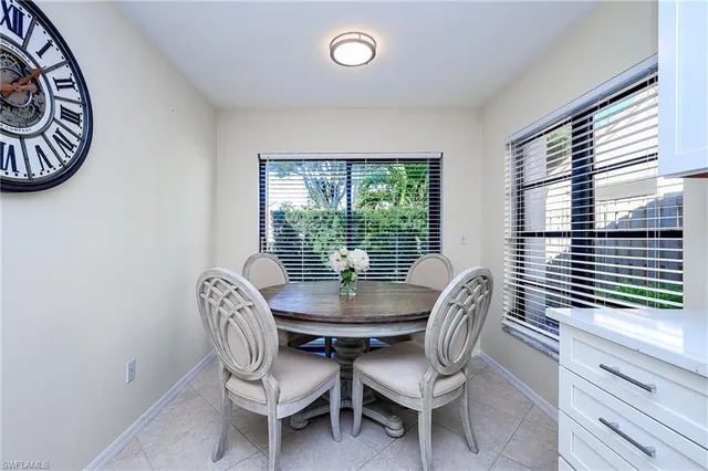 a dining room with furniture a chandelier and window