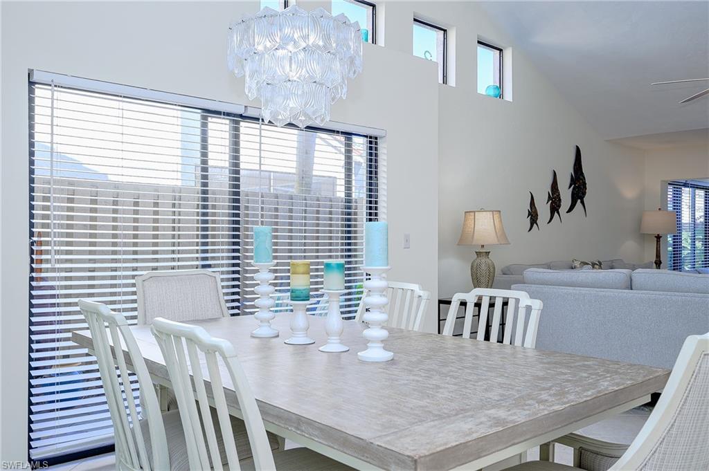 833 Reef Point Circle Naples, FL 34108 - Photo 7 of 41 Dining room with a chandelier