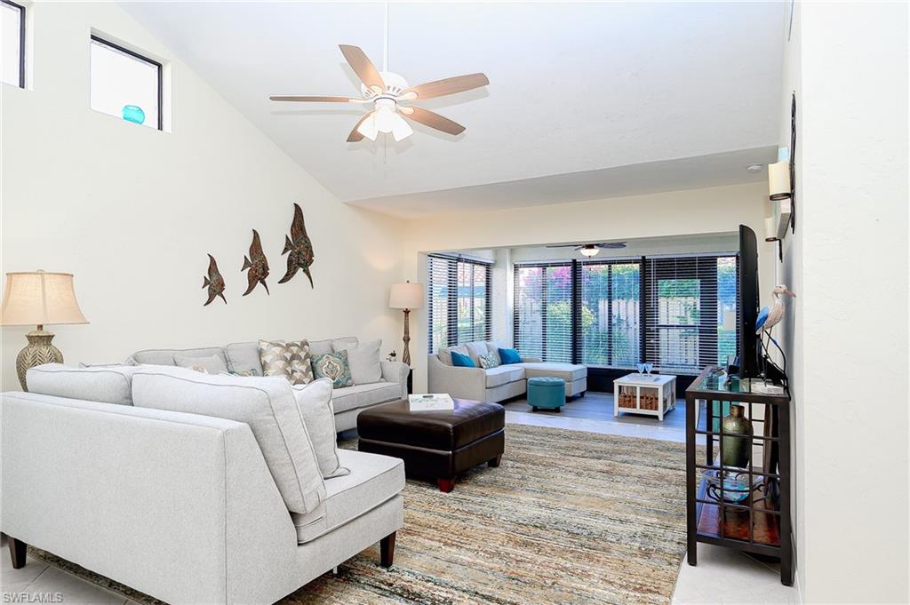 833 Reef Point Circle Naples, FL 34108 - Photo 10 of 41 Living area featuring a ceiling fan and high vaulted ceiling