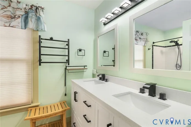 a bathroom with a sink double vanity and a mirror