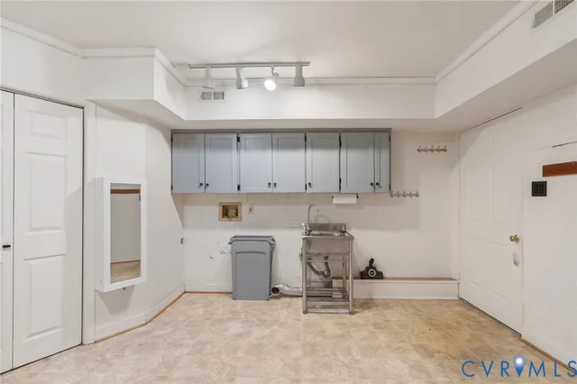 a view of a storage & utility room with cabinets