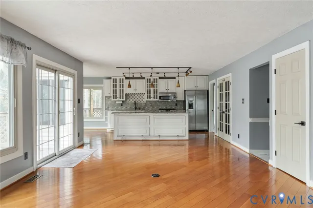 a view of a kitchen with a sink and refrigerator