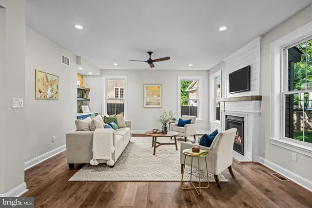 a living room with fireplace furniture and a flat screen tv