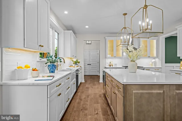 a kitchen with stainless steel appliances a sink stove and cabinets