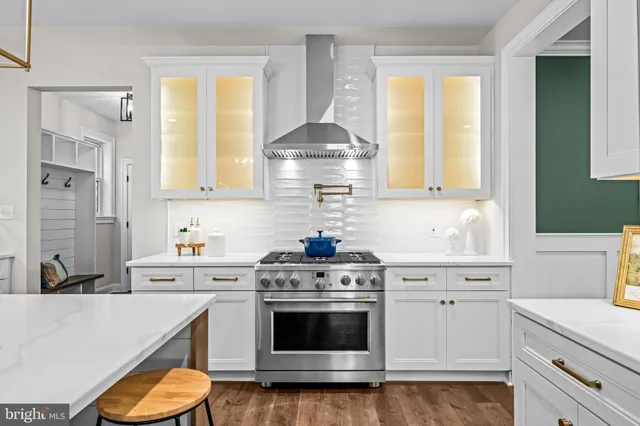 a kitchen with stainless steel appliances granite countertop a sink stove and cabinets