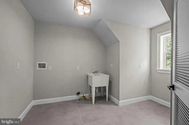 a spacious bedroom with a large bed and a window