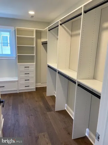 a view of walk in closet with empty racks