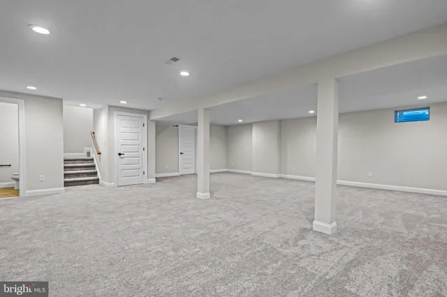 a view of a house with a yard and a tree