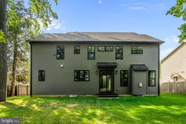 an aerial view of a house with swimming pool garden and patio