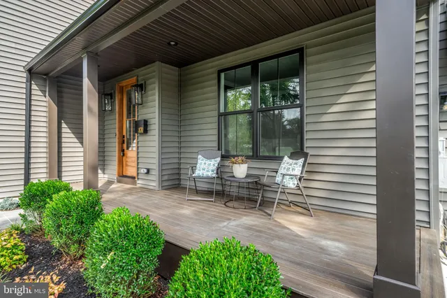 a view of a patio with table and chairs and wooden floor