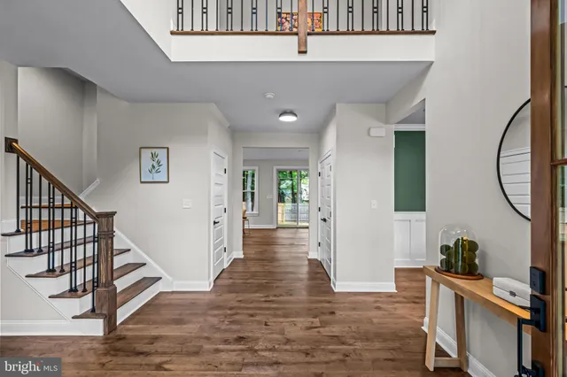 a view of a livingroom with wooden floor and furniture