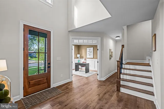 a view of a hallway with wooden floor and windows