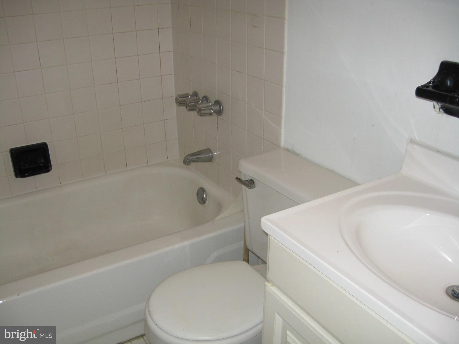 1048 South Street, Unit 3 Philadelphia, PA 19147 - Photo 6 of 9 a white toilet sitting next to a bath tub