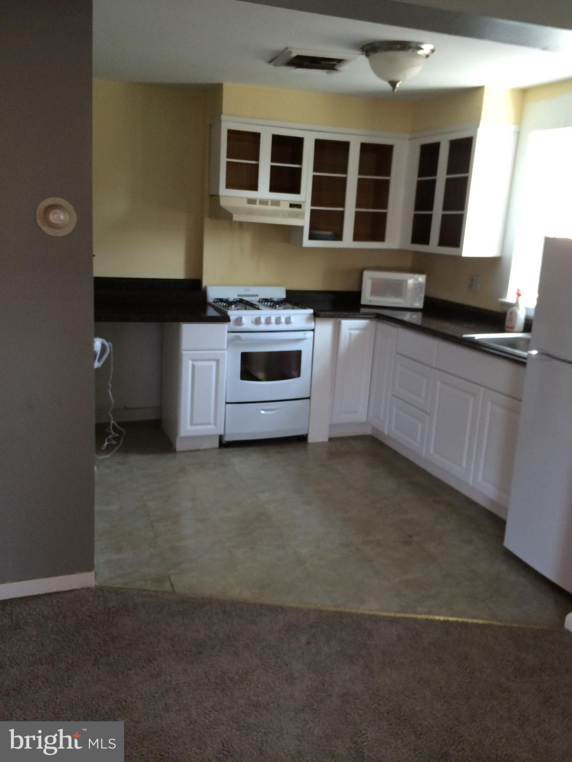 1048 South Street, Unit 3 Philadelphia, PA 19147 - Photo 8 of 9 a kitchen with stainless steel appliances a stove and a refrigerator