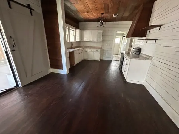 a view of a kitchen with a dishwasher and wooden floor