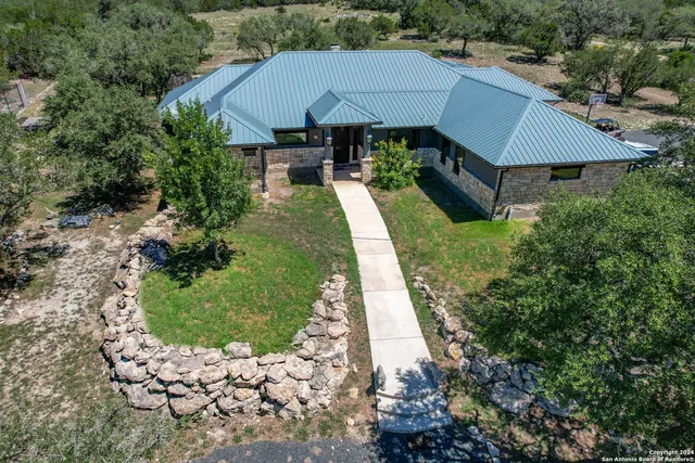 an aerial view of a house with yard swimming pool and outdoor seating