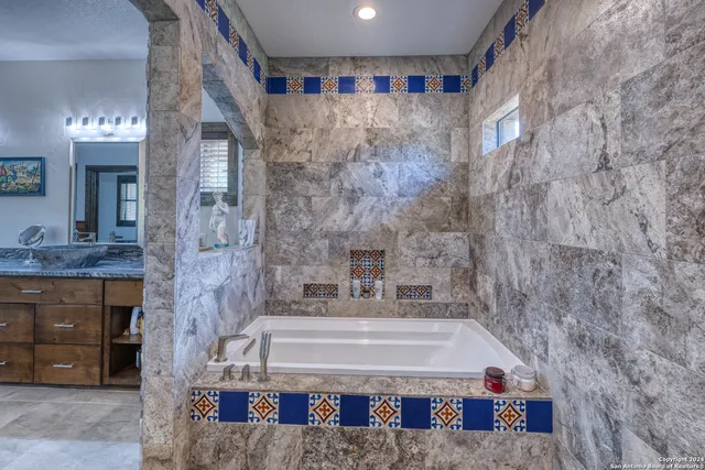 a bathroom with a bathtub and a sink