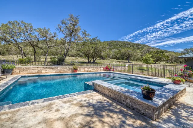 a view of a swimming pool with a patio