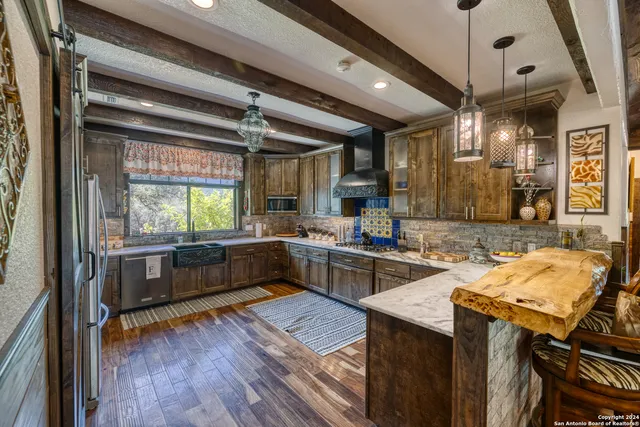 a kitchen with a stove a sink a counter top space and furniture