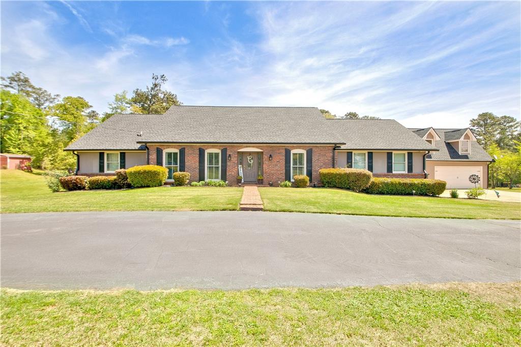 7040 Hobgood Road South Fulton, GA 30213 - Photo 1 of 1 a front view of a house with a yard and potted plants