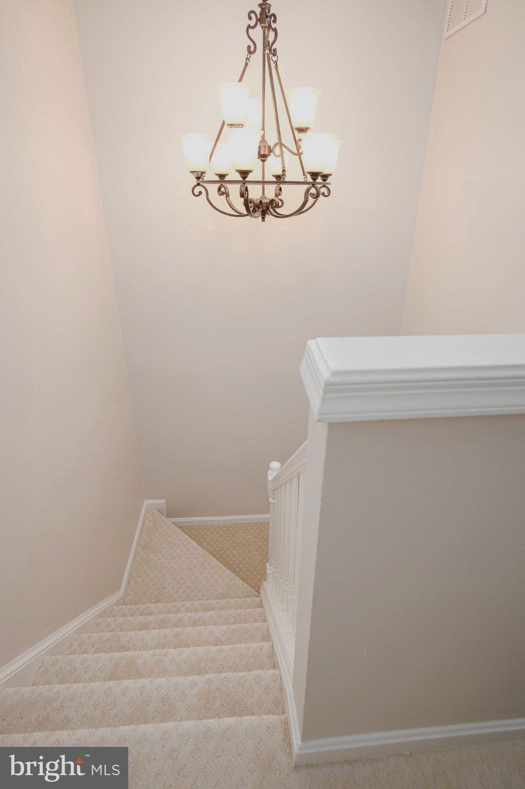 114 Gentlebrook Road Owings Mills, MD 21117 - Photo 16 of 20 Elegant staircase with chandelier glow.