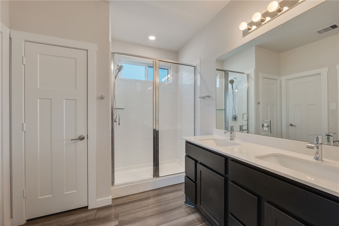 768 Double Mountain Road College Station, TX 77845 - Photo 12 of 28 a bathroom with a double vanity sink and a mirror