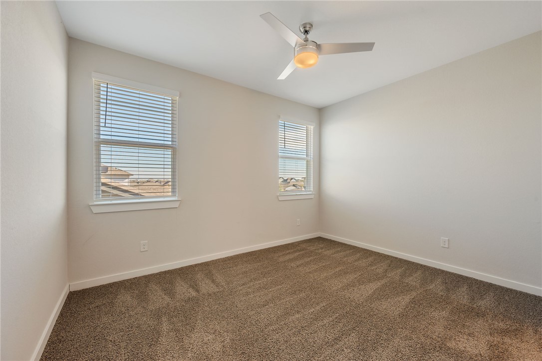 768 Double Mountain Road College Station, TX 77845 - Photo 21 of 28 an empty room with windows and fan