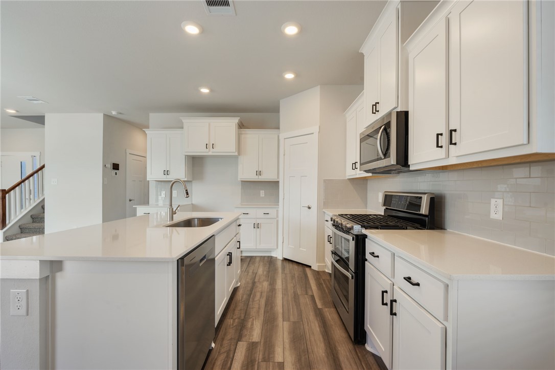 768 Double Mountain Road College Station, TX 77845 - Photo 5 of 28 a kitchen with stainless steel appliances granite countertop a sink stove and refrigerator