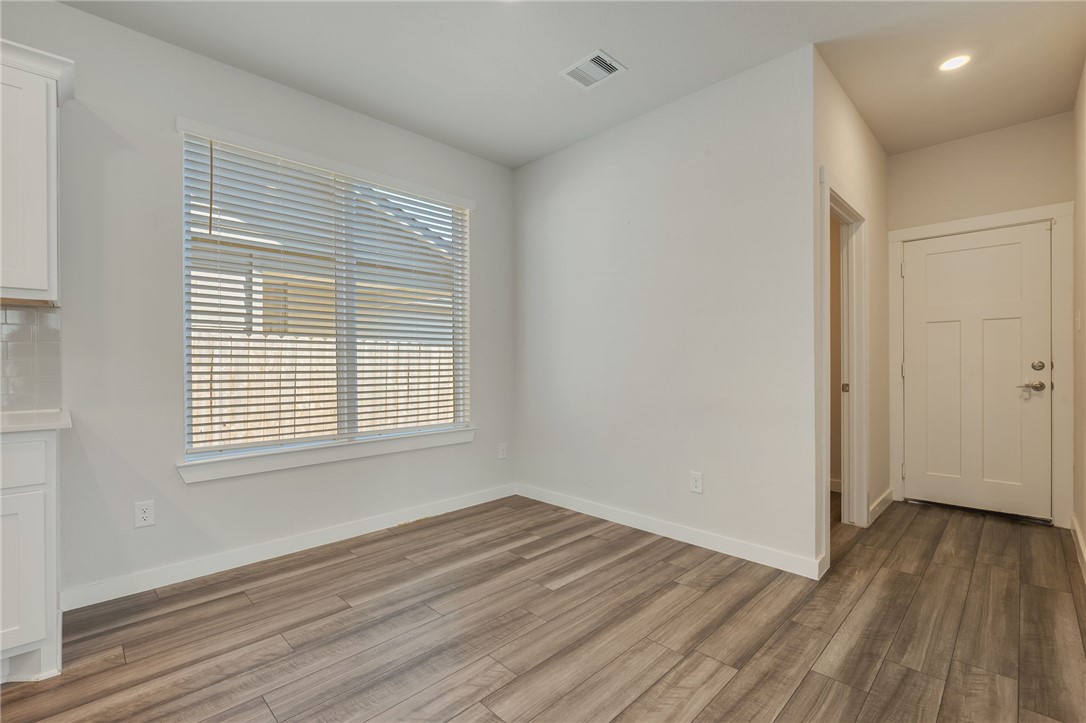 768 Double Mountain Road College Station, TX 77845 - Photo 7 of 28 a view of an empty room with wooden floor and a window