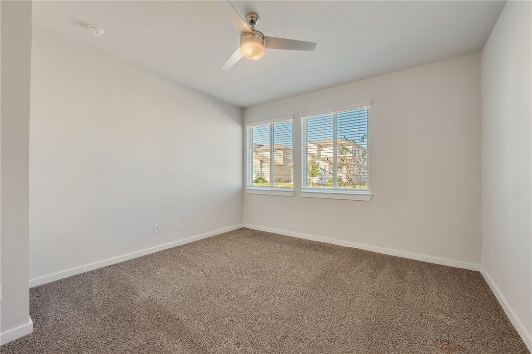 768 Double Mountain Road College Station, TX 77845 - Photo 10 of 28 an empty room with a window and ceiling fan